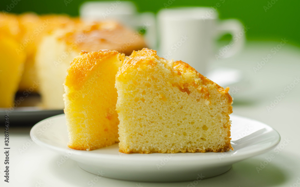 Portion of Madeira ring loaf cake served on a small plate Portion of Madeira ring loaf cake served on a small plate