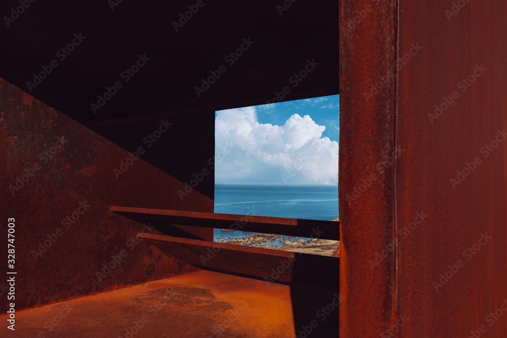 Fototapeta premium A viewpoint next to the Mediterranean sea overlooking the sea with rocks and a large cloud the background with the blue sky