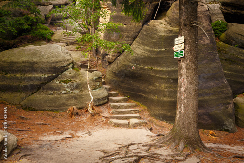 Series of stairs and steps carved in a sandstone, leading to Supi Hnizdo (vulture's nest) on a beautiful hiking trail in Czech Switzerland, Czechia photo