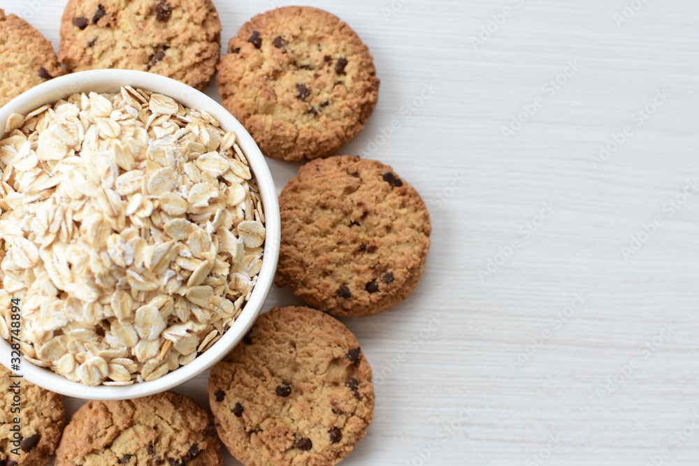 Oatmeal cookies and chocolate chips on light background Oatmeal cookies and chocolate chips on light background