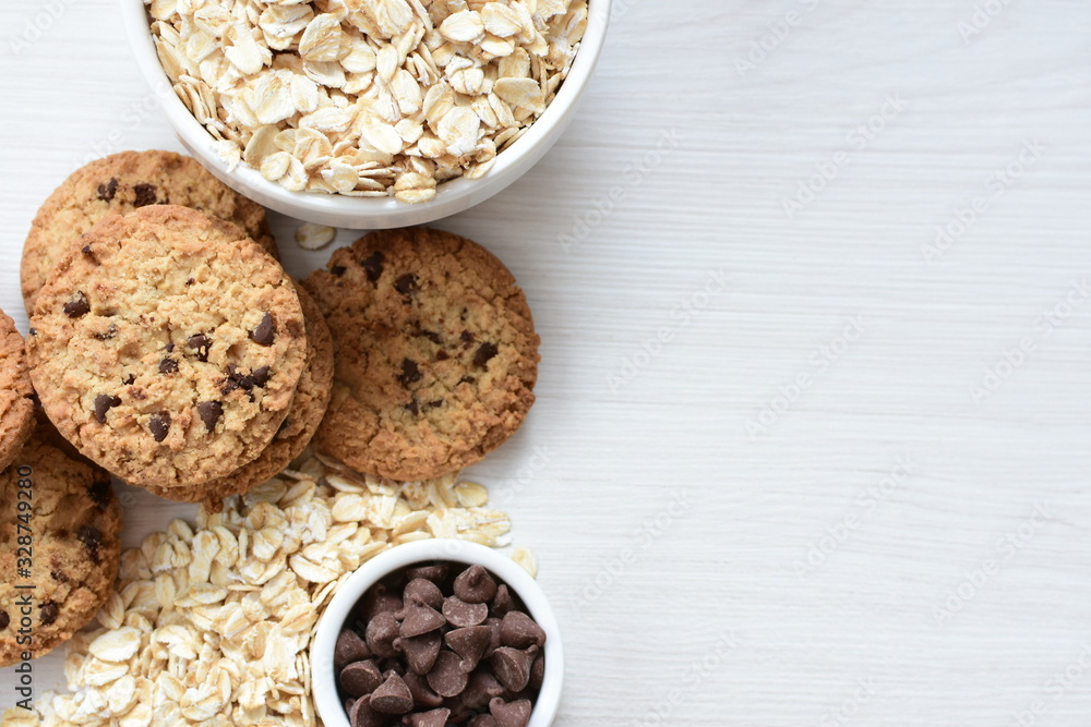 Oatmeal cookies and chocolate chips on light background Oatmeal cookies and chocolate chips on light background