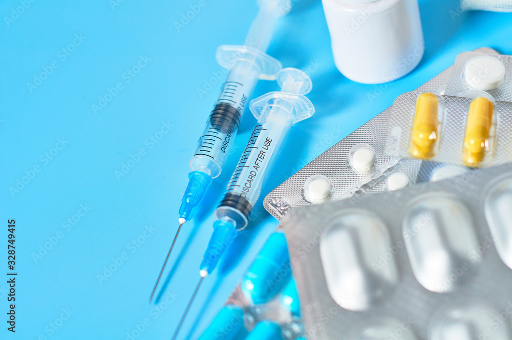 Different medicaments for disease treatment on blue background. Medical concept Different medicaments for disease treatment on blue background. Medical concept
