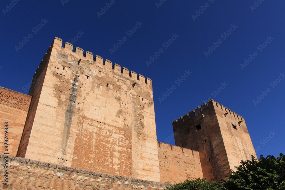 Watch and arms towers of Alcazaba fortress at the historical Alhambra Palace complex in Granada, Andalusia, Spain.