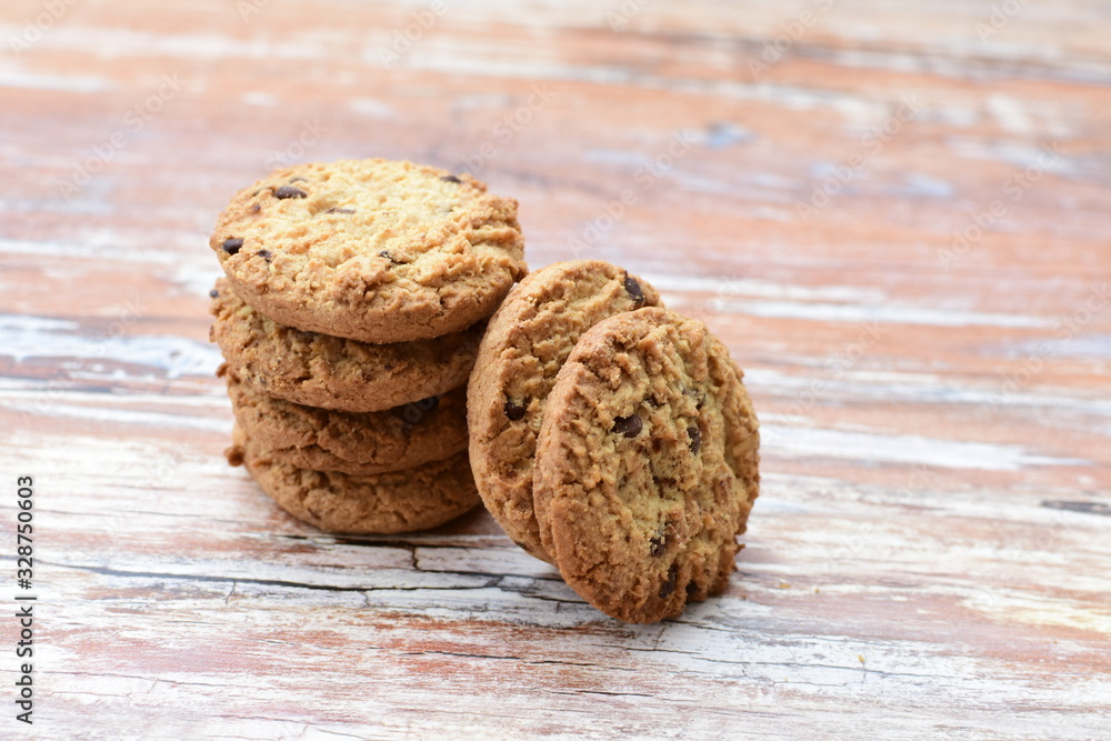 Oatmeal cookies and chocolate chips on light background Oatmeal cookies and chocolate chips on light background