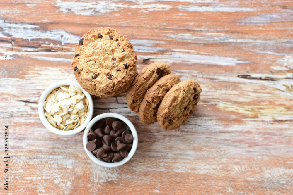 Oatmeal cookies and chocolate chips on light background Oatmeal cookies and chocolate chips on light background