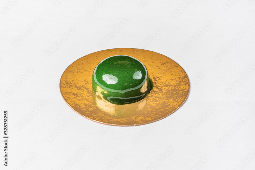 Candy in green glaze on a golden substrate Candy in green glaze on a golden substrate