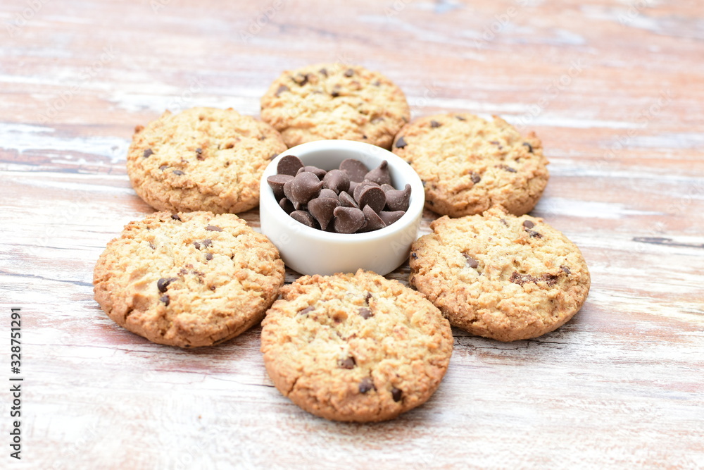 Oatmeal cookies and chocolate chips on light background Oatmeal cookies and chocolate chips on light background