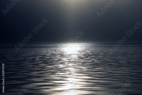 Sparkling water background: "star effect" from sun reflections.