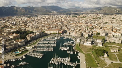 Flight over the harbour of Palermo early sunny morning. Busy traffic on the waterfront. Two kayaks floating among yachts. Sicily, Italy. May 2019. Aerial shot