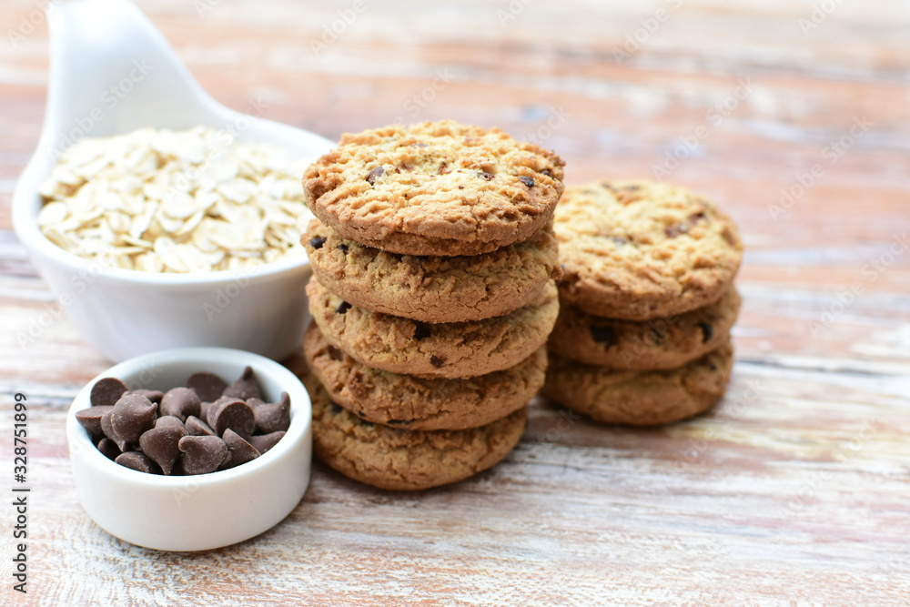 Oatmeal cookies and chocolate chips on light background Oatmeal cookies and chocolate chips on light background