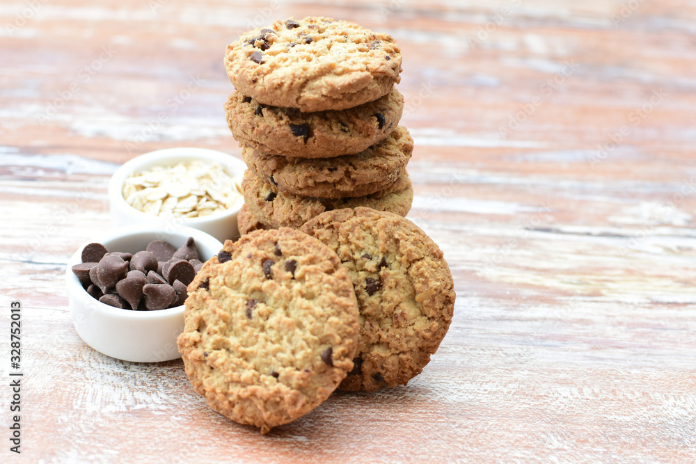 Oatmeal cookies and chocolate chips on light background Oatmeal cookies and chocolate chips on light background