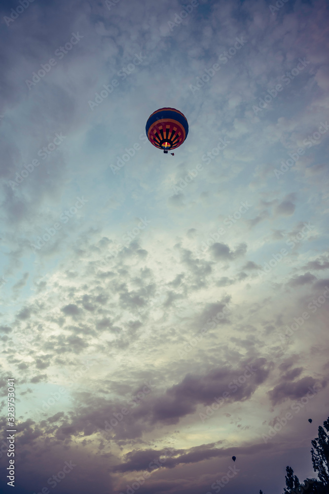 Obraz premium stock photography hot air balloon flying in sunset sky