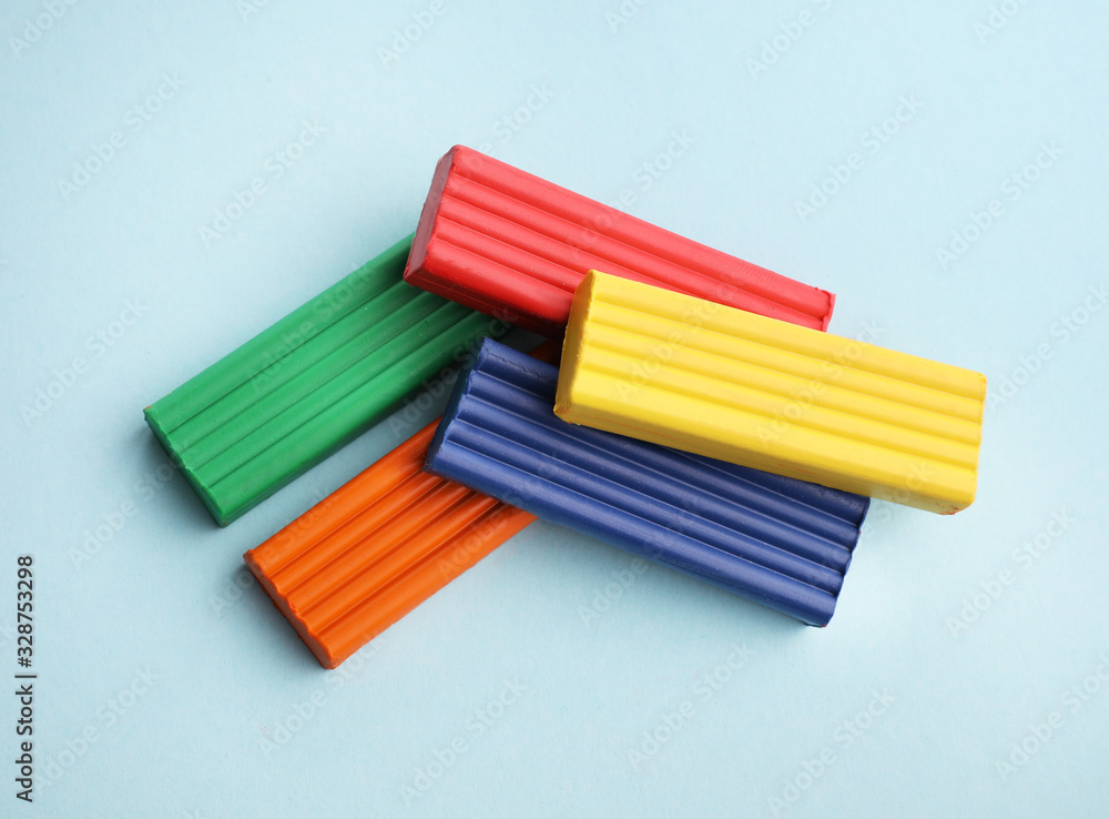 Fototapeta premium Multi-colored plasticine on blue background