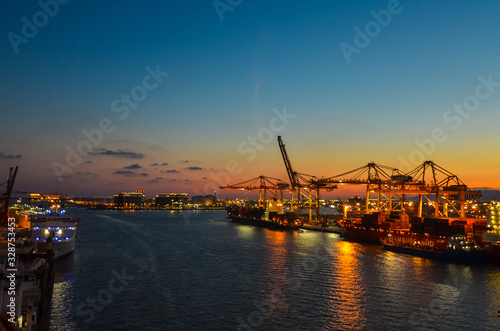 Elevated view onto the Port of Hamburg (Hamburg Hafen), Germany at sunset. The Port of Hamburg is Germanys biggest port, located at the Elbe river.