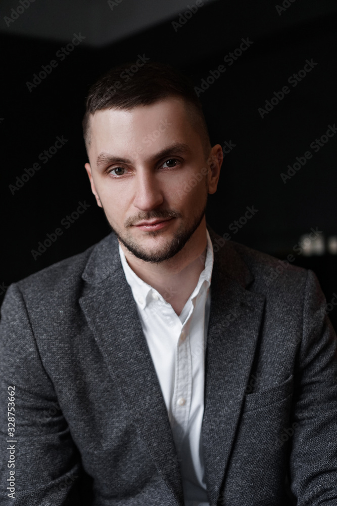 Portrait of a young attractive handsome elegant man on dark background Portrait of a young attractive handsome elegant man on dark background