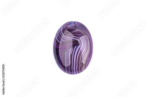 Oval cabochon stone of purple color on a white isolated background