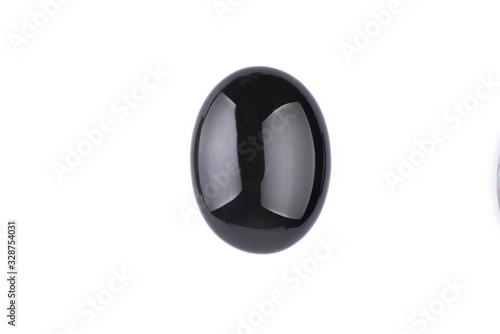 Oval cabochon stone in black on a white isolated background photo