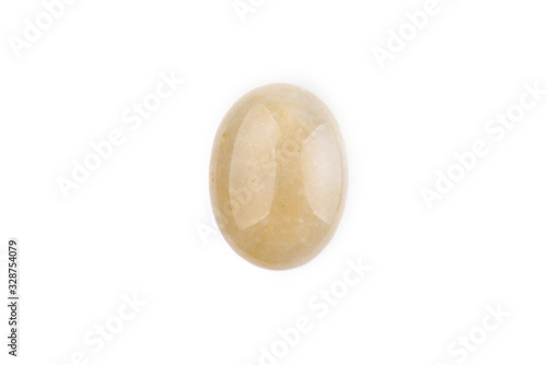 Oval yellow cabochon stone on a white isolated background