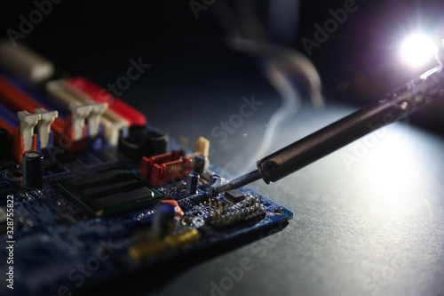 soldering iron with smoke in workshop close up