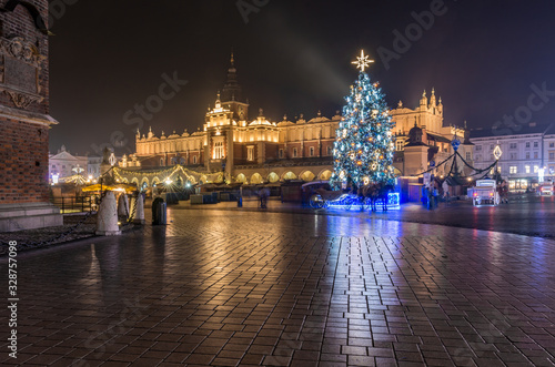 Krakow, Poland, Main Square and Cloth Hall in the winter season, during Christmas fairs decorated with Christmas tree.