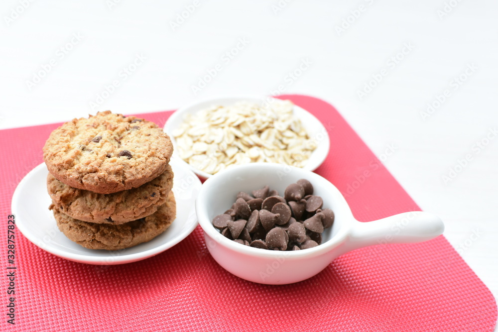 Oatmeal cookies and chocolate chips on colorful background Oatmeal cookies and chocolate chips on colorful background