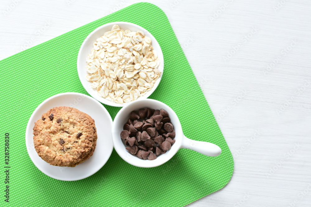 Oatmeal cookies and chocolate chips on colorful background Oatmeal cookies and chocolate chips on colorful background