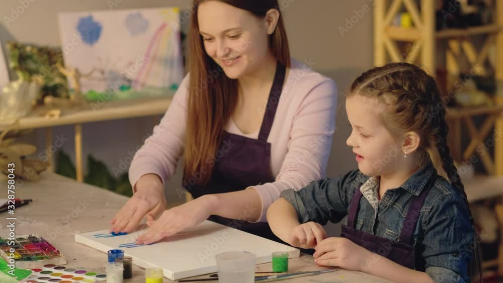 Art therapy. Family bonding. Mother young daughter enjoying finger painting. Art therapy. Family bonding. Mother young daughter enjoying finger painting.