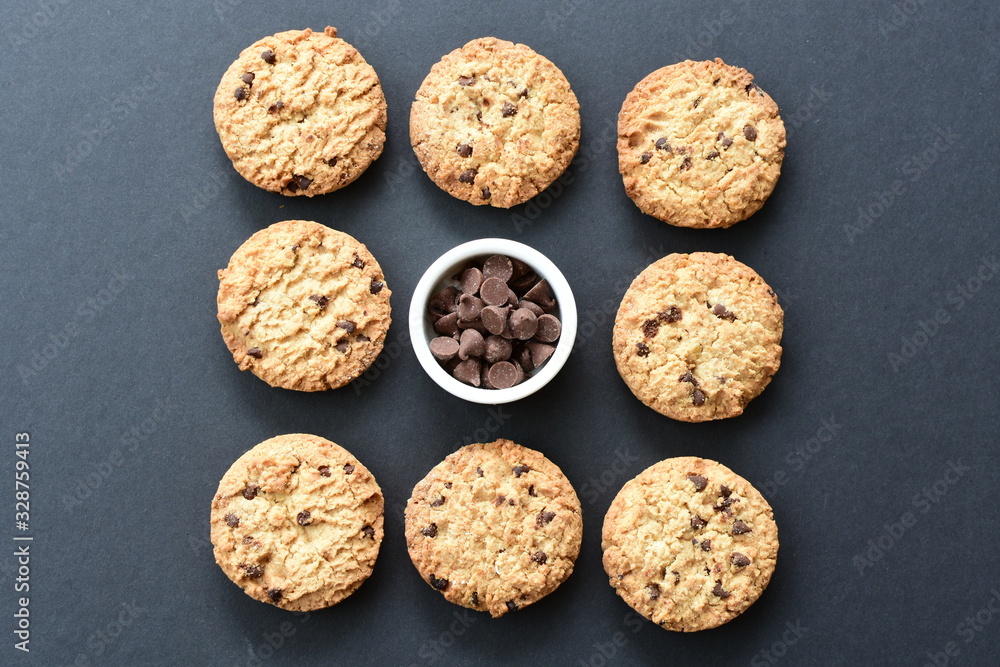 Oatmeal cookies and chocolate chips on black background Oatmeal cookies and chocolate chips on black background