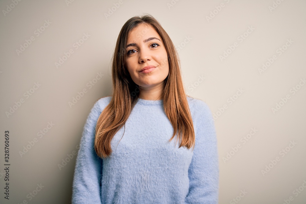 Beautiful young woman wearing casual winter sweater standing over isolated background Relaxed with serious expression on face. Simple and natural looking at the camera. Beautiful young woman wearing casual winter sweater standing over isolated background Relaxed with serious expression on face. Simple and natural looking at the camera.