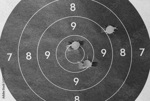 Close up of a shooting target and bullseye with bullet holes
