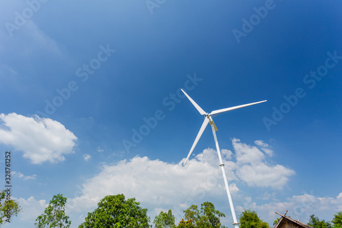 A small wind turbine in the blue sky, environment concept