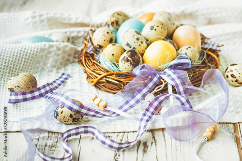 Easter eggs in a nest with decorative ribbons, selective focus.