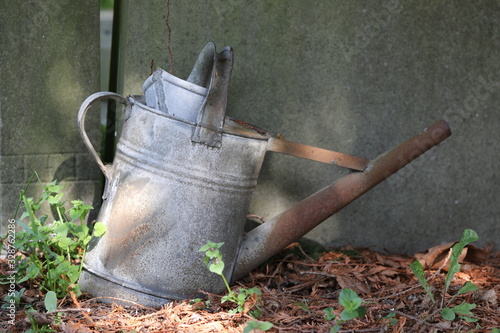 rusty metal watering can in the garden © Edwin Butter