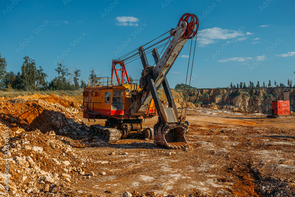 Excavator machine works in limestone pit quarry Excavator machine works in limestone pit quarry