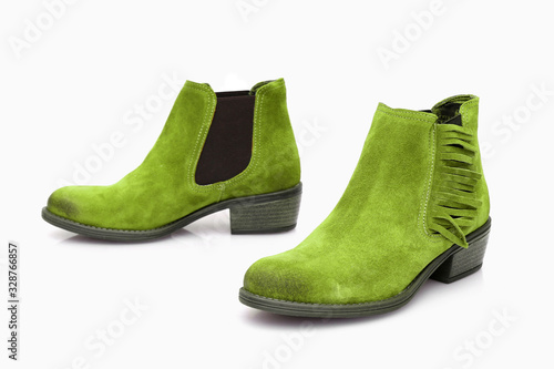 Female green leather boots on white background, isolated product, top view.