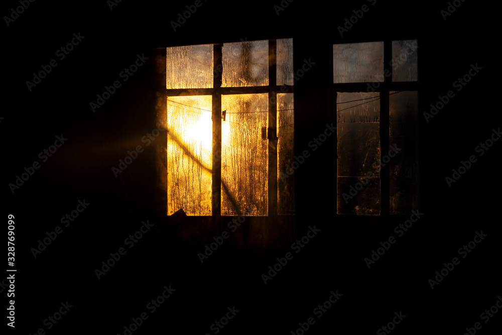 Sunrise outside the window. Misted glass against the backdrop of the rising sun. Winter morning. . Simple background. The ratio of cold and warm colors. Texture of water condensate on glass. Sunrise outside the window. Misted glass against the backdrop of the rising sun. Winter morning. . Simple background. The ratio of cold and warm colors. Texture of water condensate on glass.