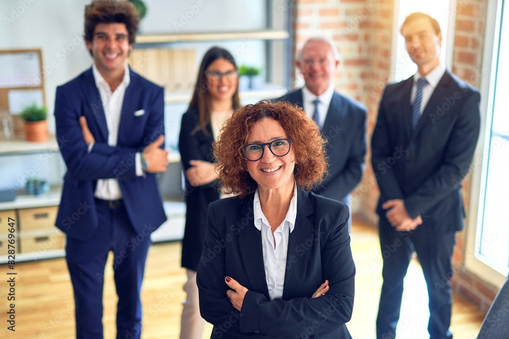 Group of business workers smiling happy and confident in a meeting. Standing with smile on face looking at camera at the office. Group of business workers smiling happy and confident in a meeting. Standing with smile on face looking at camera at the office.