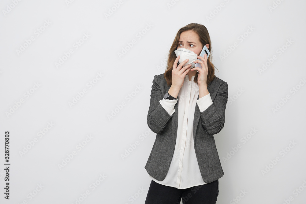 Businesswoman is afraid for getting pandemic disease Corona virus 2019-nCoV is talking on the phone Businesswoman is afraid for getting pandemic disease Corona virus 2019-nCoV is talking on the phone