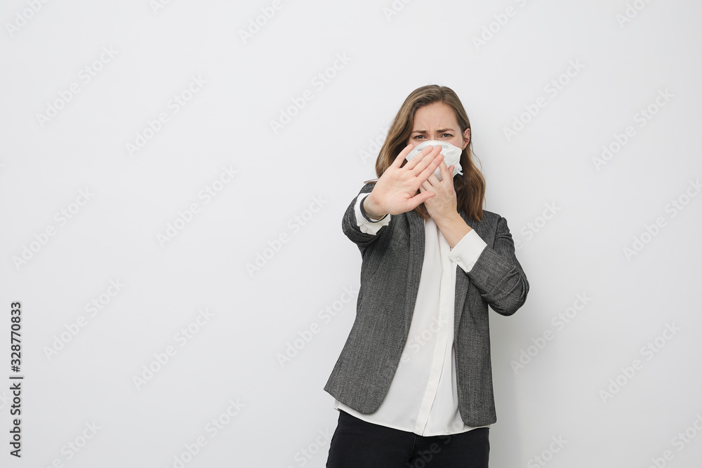 Businesswoman is afraid of getting Corona virus covid-19 pandemic saying stop while holding a protection mask Businesswoman is afraid of getting Corona virus covid-19 pandemic saying stop while holding a protection mask