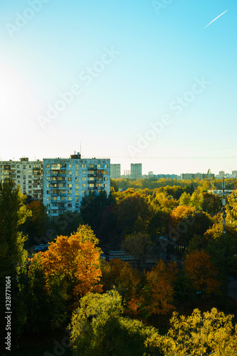 Dense urban development, buildings, city at sunrise and dawn. Sun flare. Smog and fog over the city.