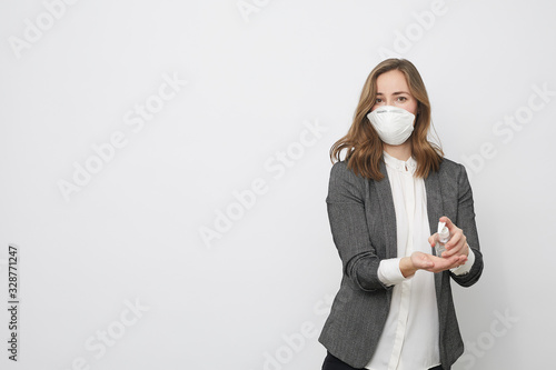 Businesswoman using rubbing alcohol to avoid Corona virus covid-19 or covid to protect herself from illness and disease photo
