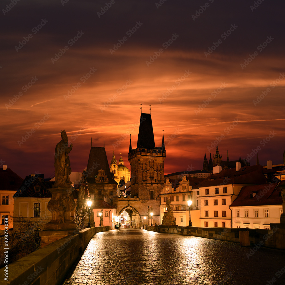 Prague, Czech Republic - Charles bridge with its statuette, Lesser Town Bridge Tower and the tower of the Judith Bridge in The Mala Strana while sunset