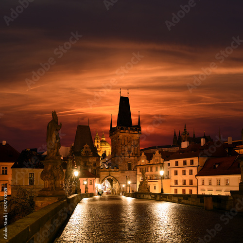 Prague  Czech Republic - Charles bridge with its statuette  Lesser Town Bridge Tower and the tower of the Judith Bridge in The Mala Strana while sunset
