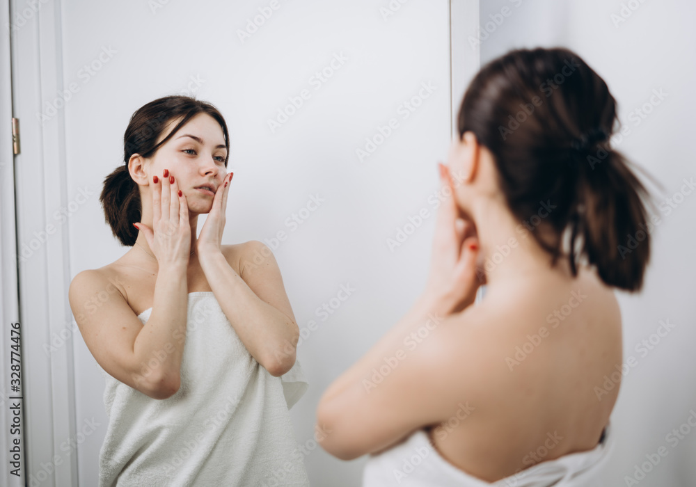 A beautiful girl massages her face with cream; genuine leather models; skin care concept A beautiful girl massages her face with cream; genuine leather models; skin care concept