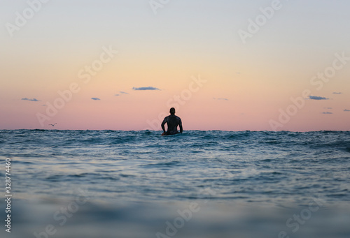 Fototapeta Naklejka Na Ścianę i Meble -  Surfer at sunset, Bronte Beach Australia