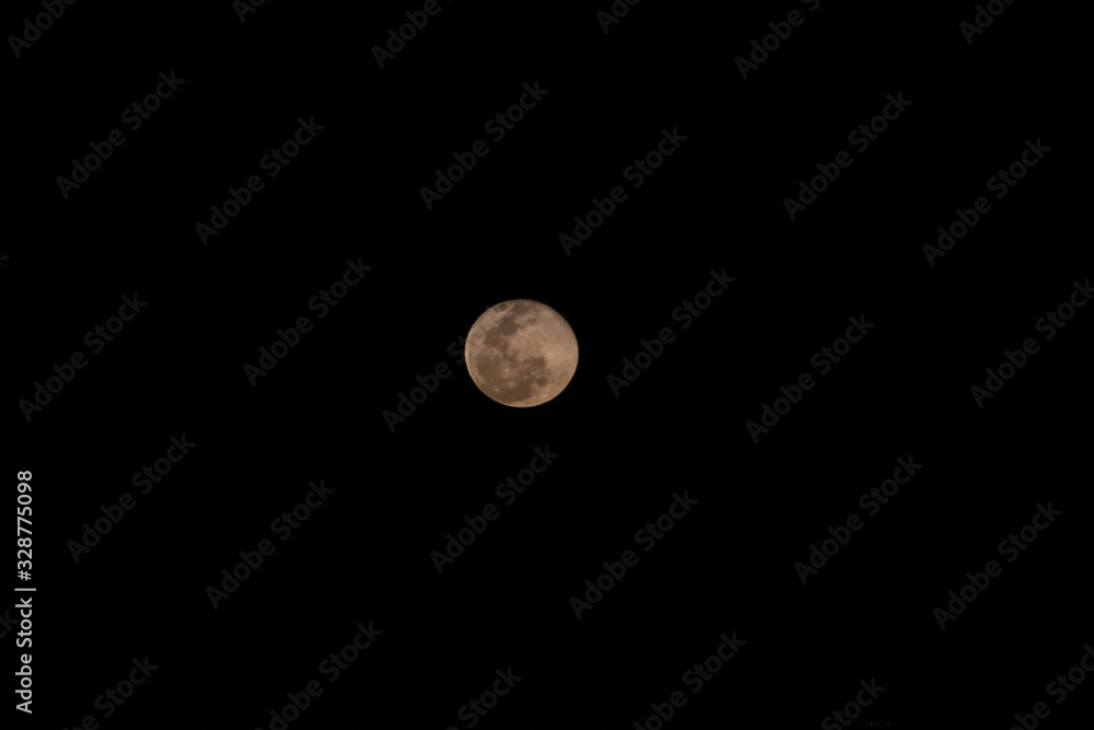 Beautiful view of the full moon rising in the horizon Beautiful view of the full moon rising in the horizon