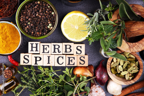 Spices and herbs on table. Food and cuisine ingredients with pepper and spices herbs sign with wooden cubes