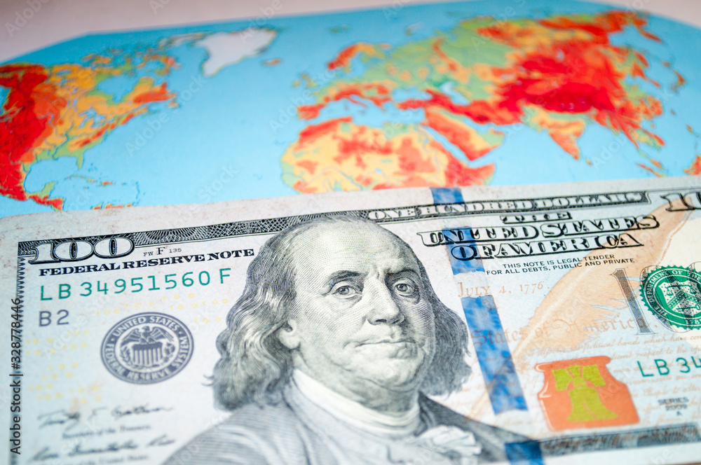 Obraz premium Money on the world map. We are planning a trip. Vacation expenses. Which country to invest in.