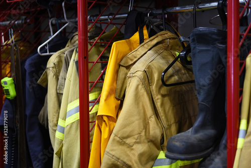 Closeup of Firefighter gear on hangers inside a fire station