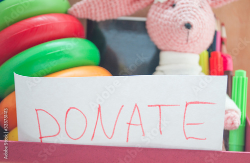 volunteer box with used toys, fabrics, books and stationery for a donation, a new life for old things